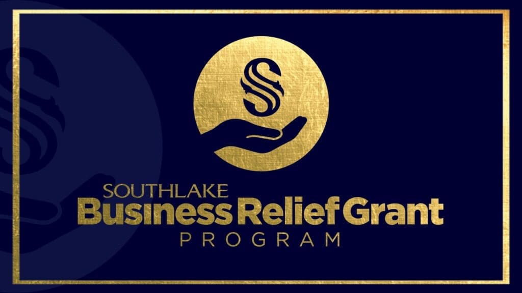 Gold text and design on a dark blue background. The text reads "Southlake Business Relief Grant Program." A gold circle features a hand holding a stylized "S." The border is gold.