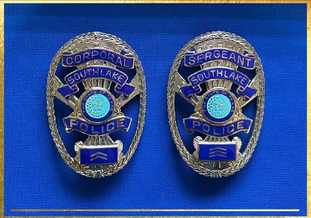 Two police badges on a blue background. The left badge reads "Corporal Southlake Police," and the right reads "Sergeant Southlake Police." Both feature blue detailing and central emblems with a star.