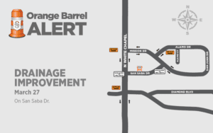Map showing a "Drainage Improvement" alert on San Saba Dr. Road closures and detours are marked. The alert date is March 27. The map includes Alamo Dr, Mission Dr, San Juan Dr, White Chapel, and Diamond Blvd. Compass rose indicates north.