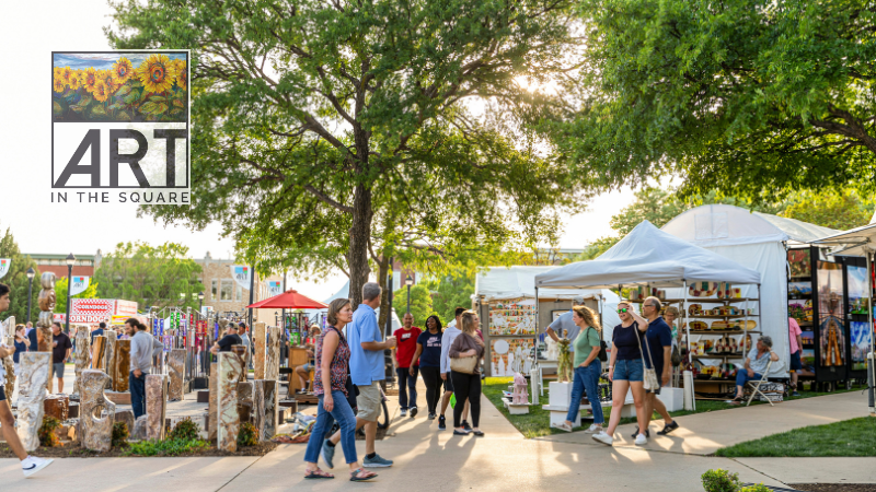 Photo of Art in the Square event 2022. Picture of people walking and looking at art.