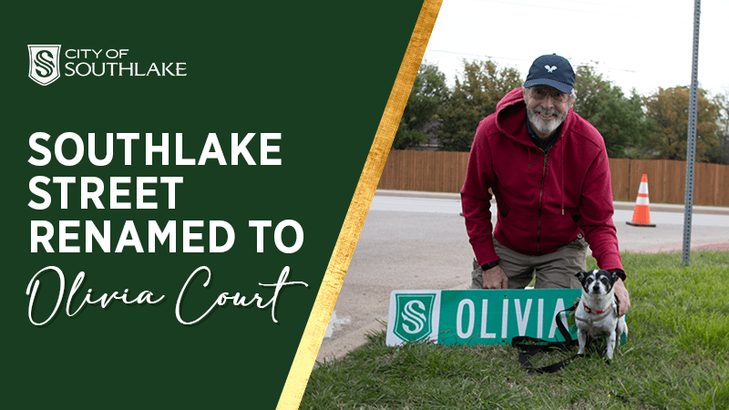A man in a red hoodie and cap kneels beside a dog, both near a new street sign that reads "Olivia Court." The image includes the text "City of Southlake" and "Southlake Street Renamed to Olivia Court" against a green background.