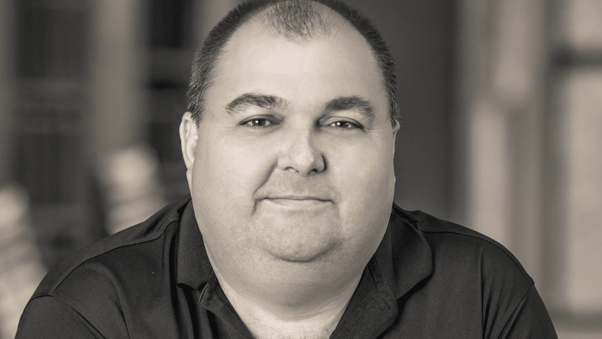 Image of author James Ponti. The image is black and white with Jame breaking a small smile.