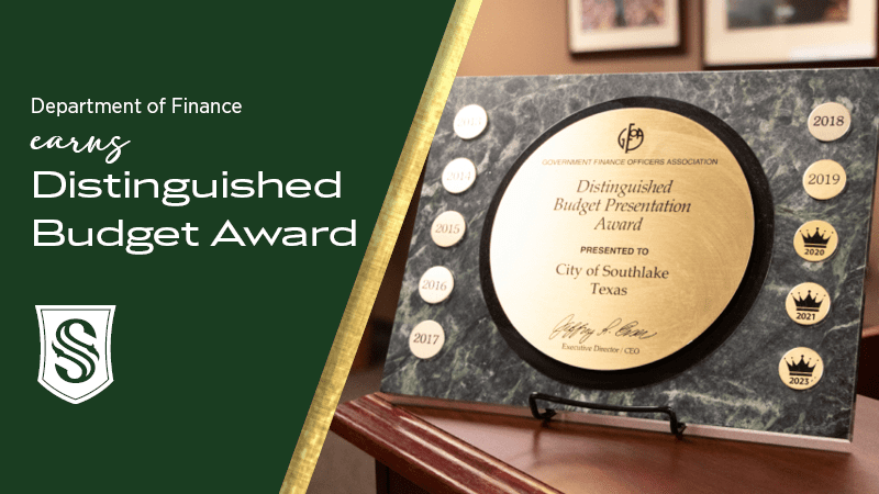 A plaque from the Government Finance Officers Association on a stand, awarded to the City of Southlake, Texas for Distinguished Budget Presentation. It includes emblems for the years 2016 to 2021 and 2023. A green text panel accompanies the image.