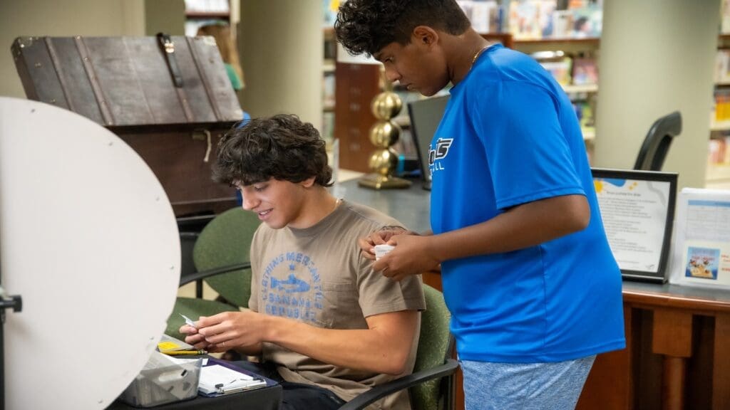 Two volunteers organizing prize drawings