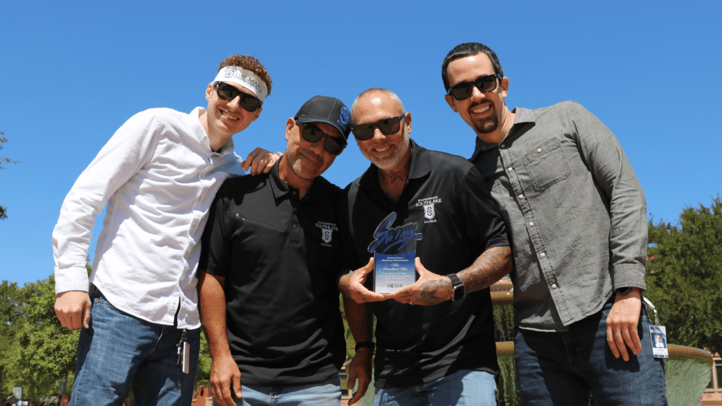 Photo of four guys smiling at the camera