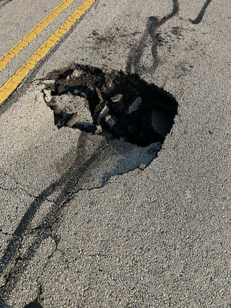 Photo of a sinkhole in the road