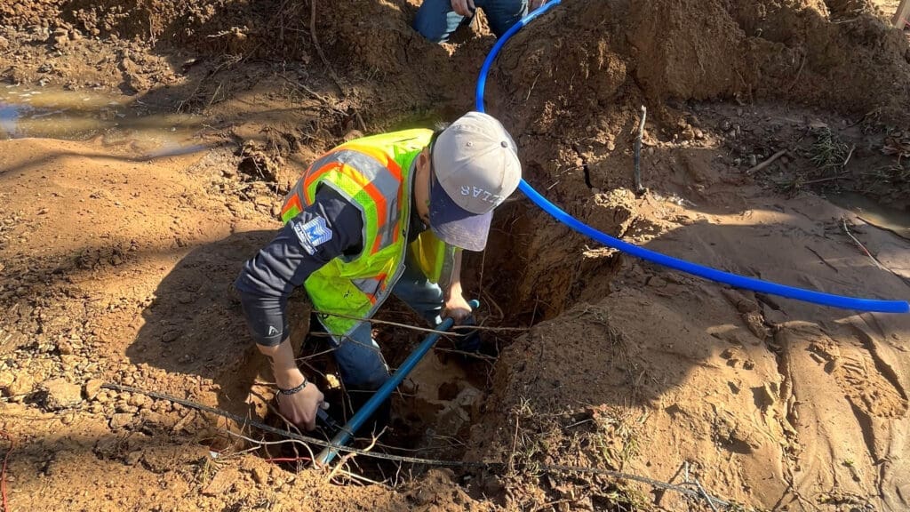 Photo of someone working on a water line