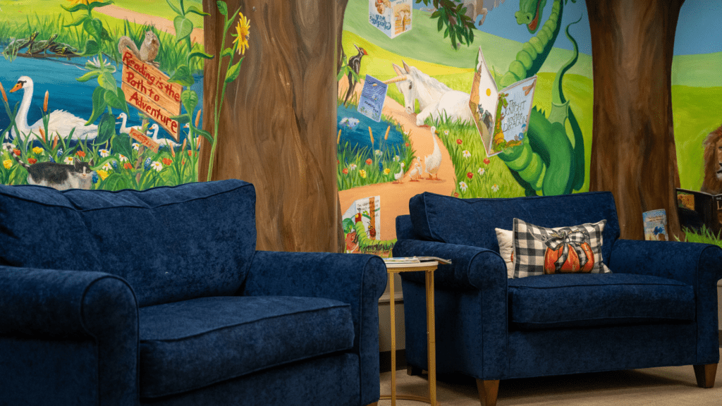Image shows a blue couch in the youth area of the library