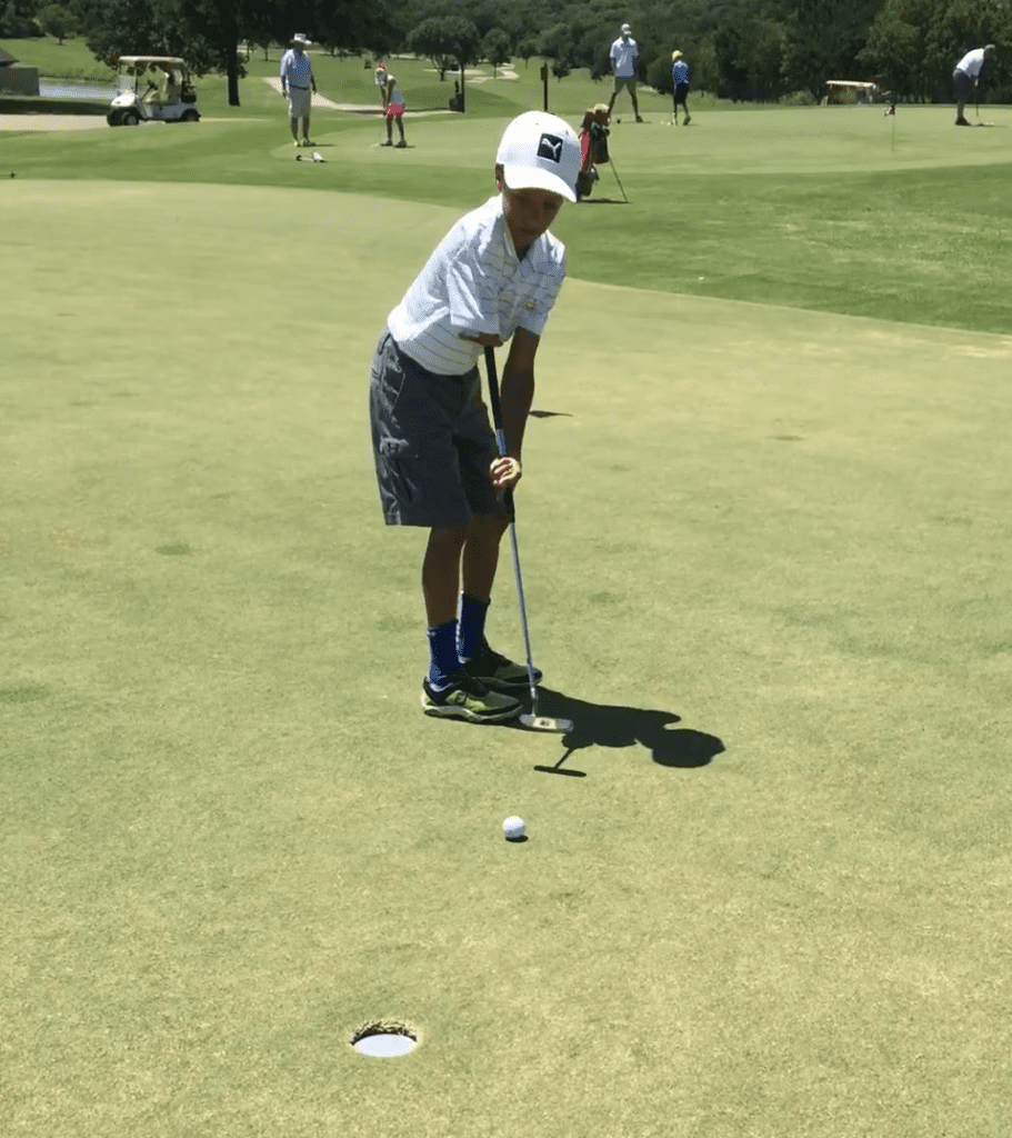 Photo of a kid golfing