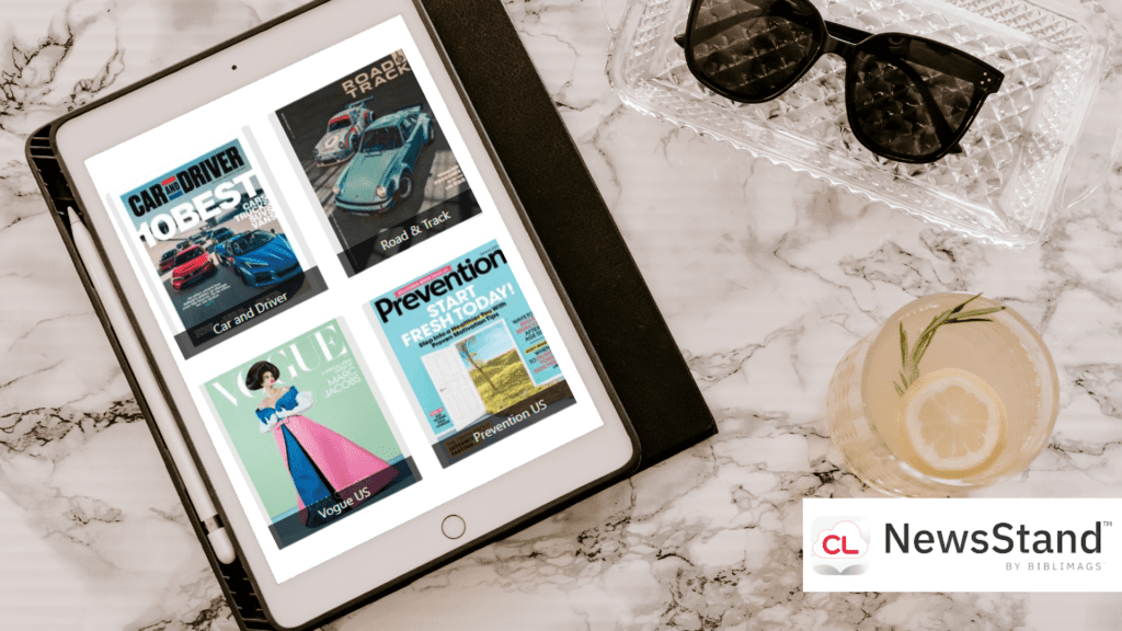 Image shows a tablet featuring magazines from NewsStand next to a drink and sunglasses.