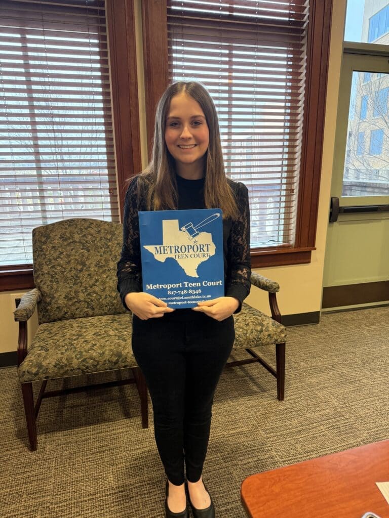 A girl smiles with a folder