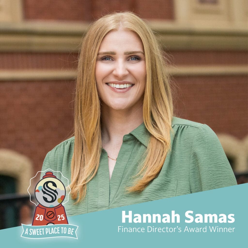 A woman with long blonde hair and a green blouse smiles in front of a brick building. Text reads "Hannah Samas, Finance Director's Award Winner" with a "2025 A Sweet Place to Be" badge in the corner.