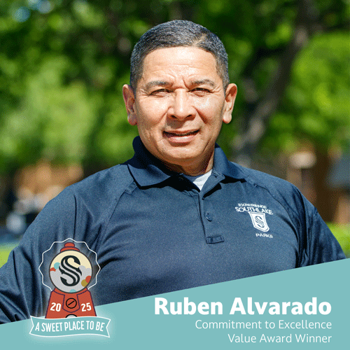 A man in a navy polo shirt with the "Southlake Parks" logo stands outdoors, smiling. Text reads: "Ruben Alvarado, Commitment to Excellence Value Award Winner." A "2025 A Sweet Place to Be" emblem is in the corner.