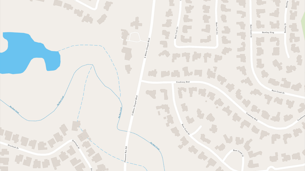 Map showing a suburban neighborhood with winding streets, houses, a small lake on the left, and a creek running through the area. Major roads include Cowbay Blvd and North Morse Chapel Rd.