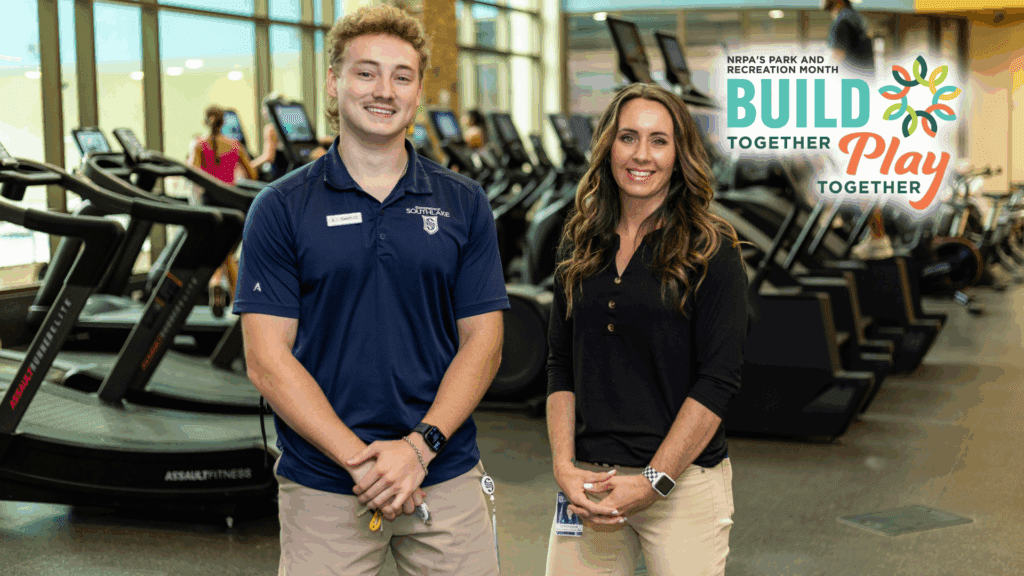 Two smiling staff members stand in a gym with treadmills in the background. A logo reads “NRPA’s Park and Recreation Month: Build Together, Play Together” in the upper right corner.