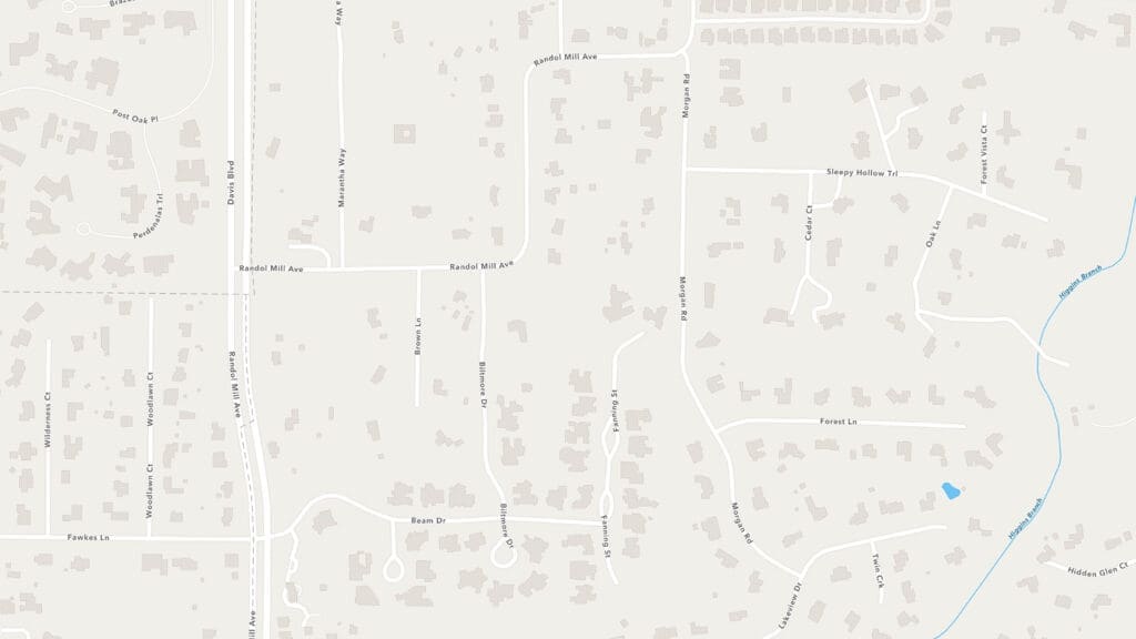 A suburban neighborhood map showing winding roads, cul-de-sacs, individual houses, and green areas. Streets include Randall Mill Ave, Sleepy Hollow Rd, and Woodward Way. A stream runs along the right side of the map.