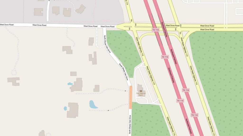A map showing the intersection of West Dove Road and TX 114. There are nearby buildings, ponds, green areas, and roads, including an overpass and on/off ramps connecting West Dove Road to TX 114.