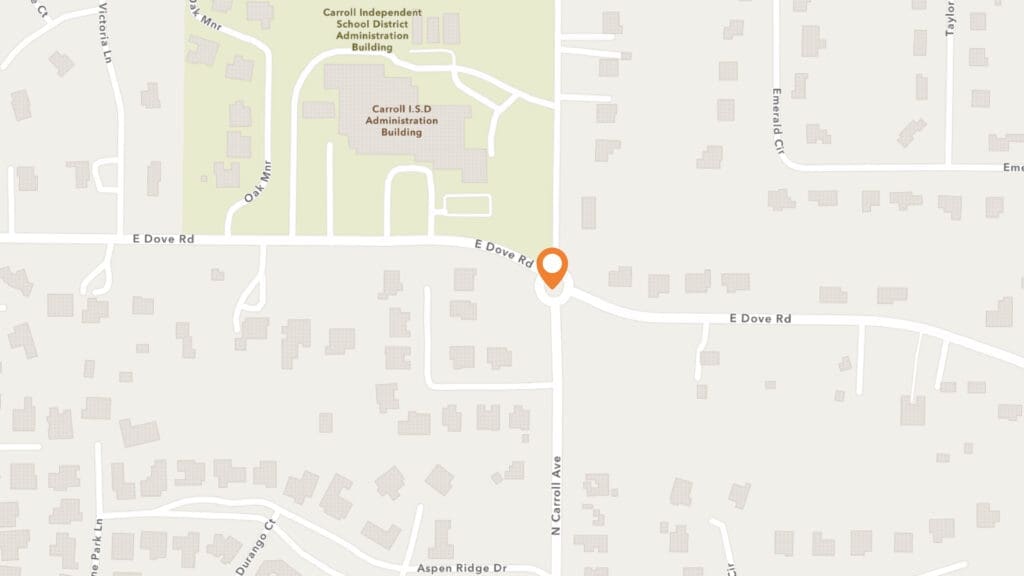 Map showing the intersection of E Dove Rd and N Carroll Ave near Carroll ISD Administration Building, marked by an orange location pin, surrounded by residential streets and buildings.
