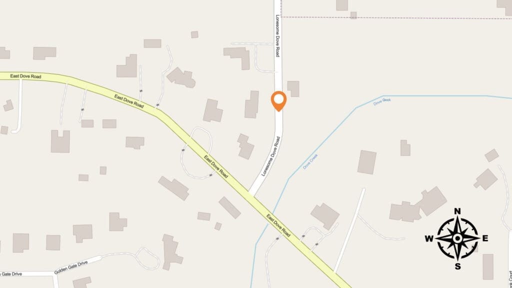 A map shows intersecting roads, including East Dove Road and Lonesome Dove Road, with buildings and a creek nearby. An orange location pin marks a spot on Lonesome Dove Road. A compass rose is in the lower right corner.
