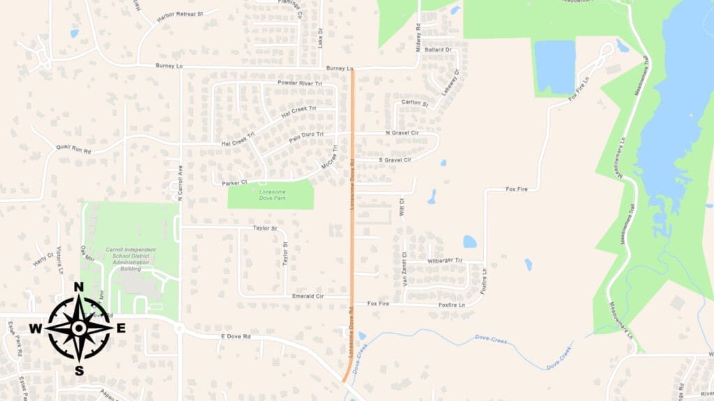 A map showing a suburban area with streets, houses, parks, and lakes. A north-south road is highlighted in orange. A compass rose is at the bottom left, and green areas mark parks and natural spaces on the right side.